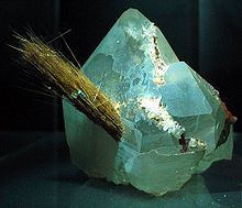 Acicular crystals of rutile protruding from a quartz crystal
