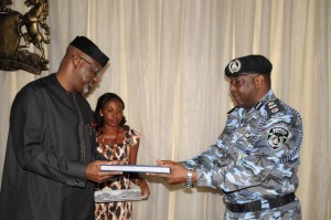 Cross River State Governor,, Senator Liyel Imoke, presenting a sourvenir to the newly posted Assistant Inspector General (AIG) of Police Zone 6, Calabar, AIG Jonathan Johnson when the service commanders paid the governor a courtesy visit today.