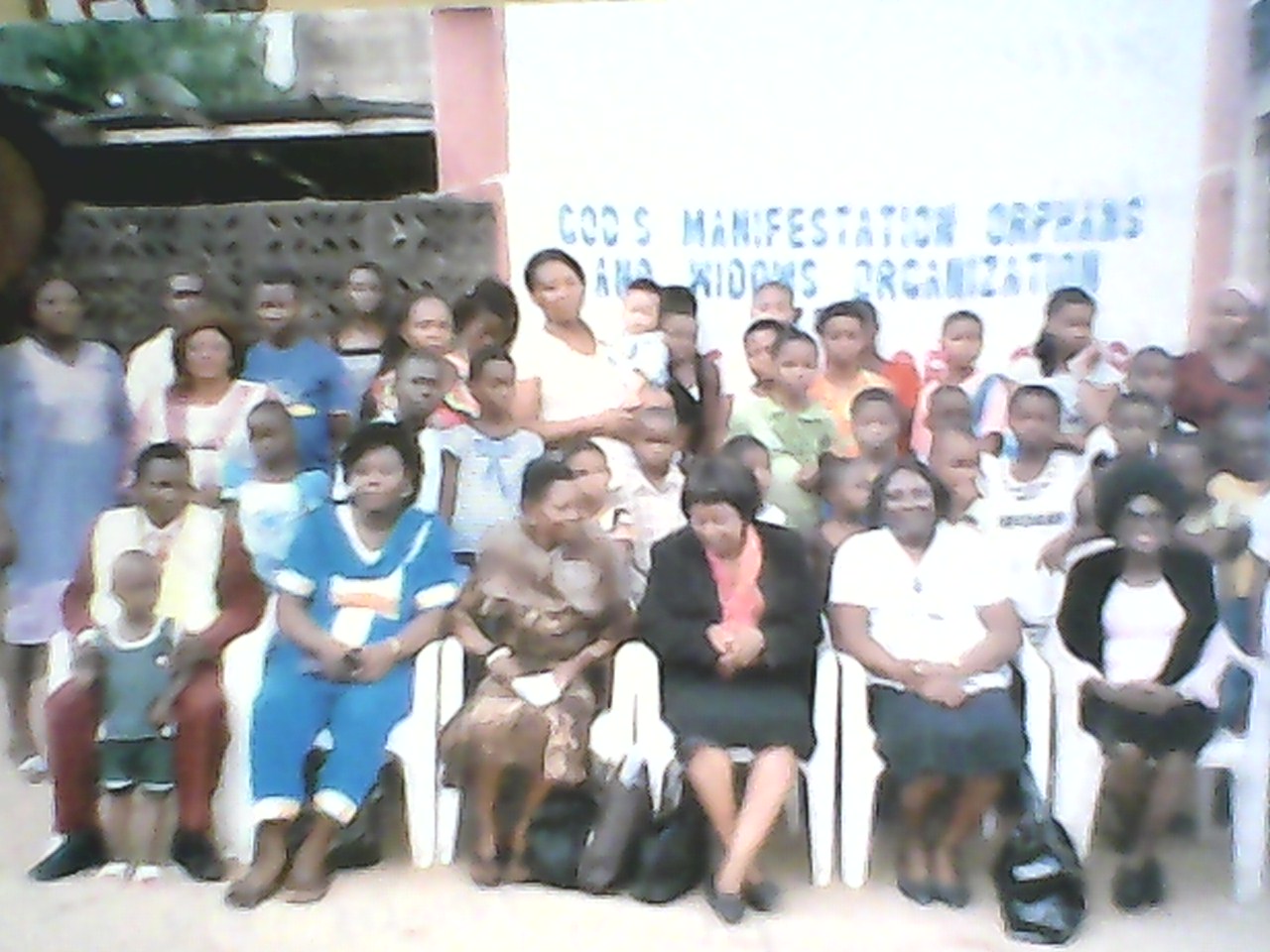 The orphans and ministry officials in a photo session