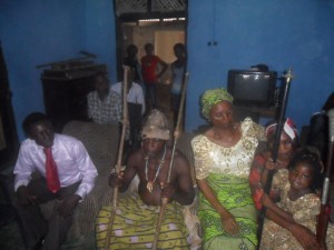 From left: Ntunkai's father, the new king of Mbarakom holding his staffs of office, Ntunkai's grand daughter, Mrs. Veronica and Ntunkai sitting on her mother's legs cluctching her two staffs of office