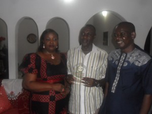 Obudu Council Boss, Hon Emmanuel Ugbe in the middle displaying the award. To his left is Kakum Development Association Calabar Branch Chairman and to his left is the Chairman's wife