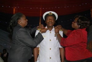 Admiral P.A. Agba, FOC, Central Naval Command, CNC being decorated by the former Minister of State for Defence, Erelu Obada (left) and his wife, Mrs. Bimbo Agba (right) on his promotion to the rank of Rear Admiral