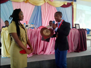 Outgone President of the club handing over the Club's bell to the new President, Kesther