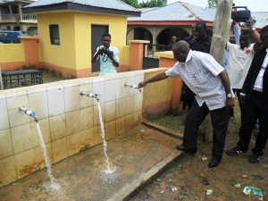 Senate Leader, Victor Ndoma Egba, SAN opening a tap faucet during the project inspection tour at Mkpani, Yakurr LGA 