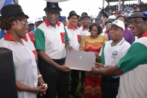 Cross River State Governor, Senator Liyel Imoke (2nd left) presenting the now controversial lap top computer to Mr. Francis Adie (2nd right), while the State NLC Chairman watches, during the May Day 2014 celebration in Calabar