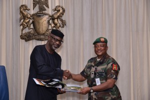 Senator Liyel Imoke presenting a souvenir to the Commander, Joint Task Force (JTF) on oil theft (Operation Pulo Shield) Maj. General Emmanuel J. Atewe, when he visited Government House, Calabar 