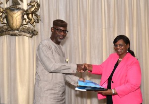 Cross River State Governor, Senator Liyel Imoke exchanging the 2014 Cross River/ UN Work Plan with country representative, Mrs. Ratidzai Ndhlovu shortly after the signing ceremony in Calabar