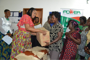 Mrs. Imoke presenting a gift to one of the widows