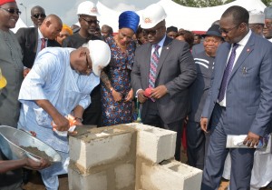 PDP National Chairman,  Alhaji Adamu Mu’azu laying foundation for the construction of 200 housing units of the Golf Estate at the Summit Hills , Calabar while Cross River State Governor, Senator Liyel Imoke and wife Obioma (behind), MD UACN Property Development Company (UPDC), Mr. Hakeem Ogunniran (R) and others look on