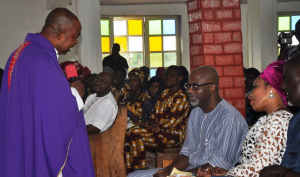 Rev. Fr. Bernard Ashipu engaging Governor Imoke during the funeral service