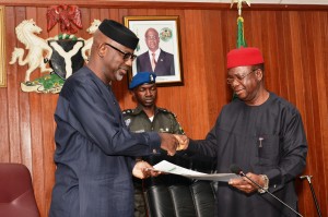 Governor Imoke of Cross River (left) and Governor Martin Elechi of Ebonyi exchanging documents after the meeting in Abakaliki