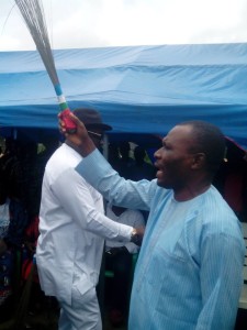 Pastor Usani Uguru Usani, Cross River State Chairman, APC brandishing the broom during the ceremony