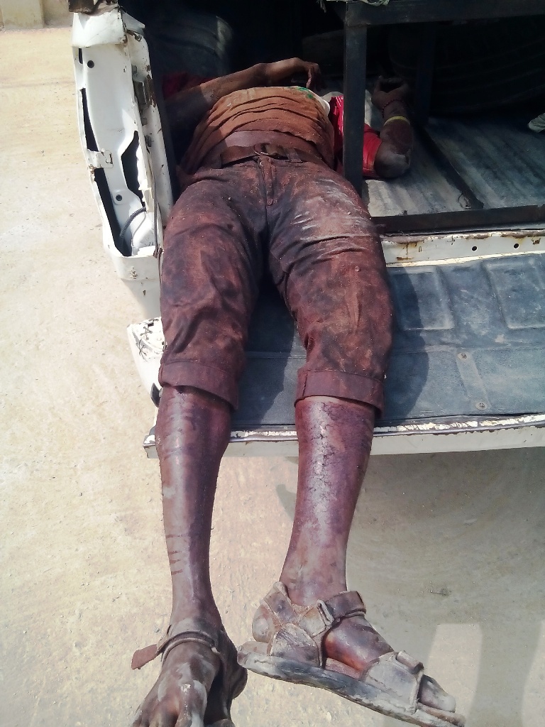 Michael, Okon's colleague lying dead in the police van