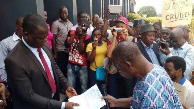 Spokesman of the protesters, Dr. Ntino (right) handing a list of their grievances to the the Vice Chancellor of CRUTECH, Professor Owan Enoh (left)