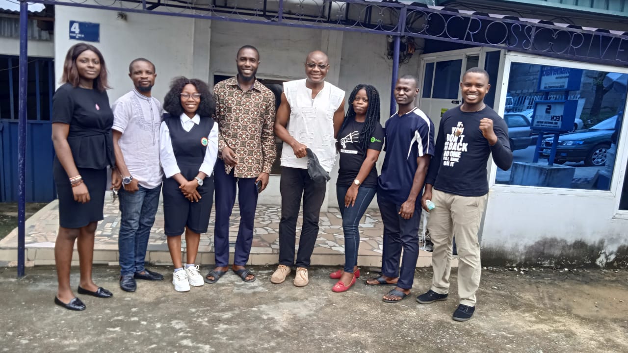 File Photo: Mr. Isine Ibanga poses with some staff of CrossRiverWatch during a visit to the office in Calabar in 2020.