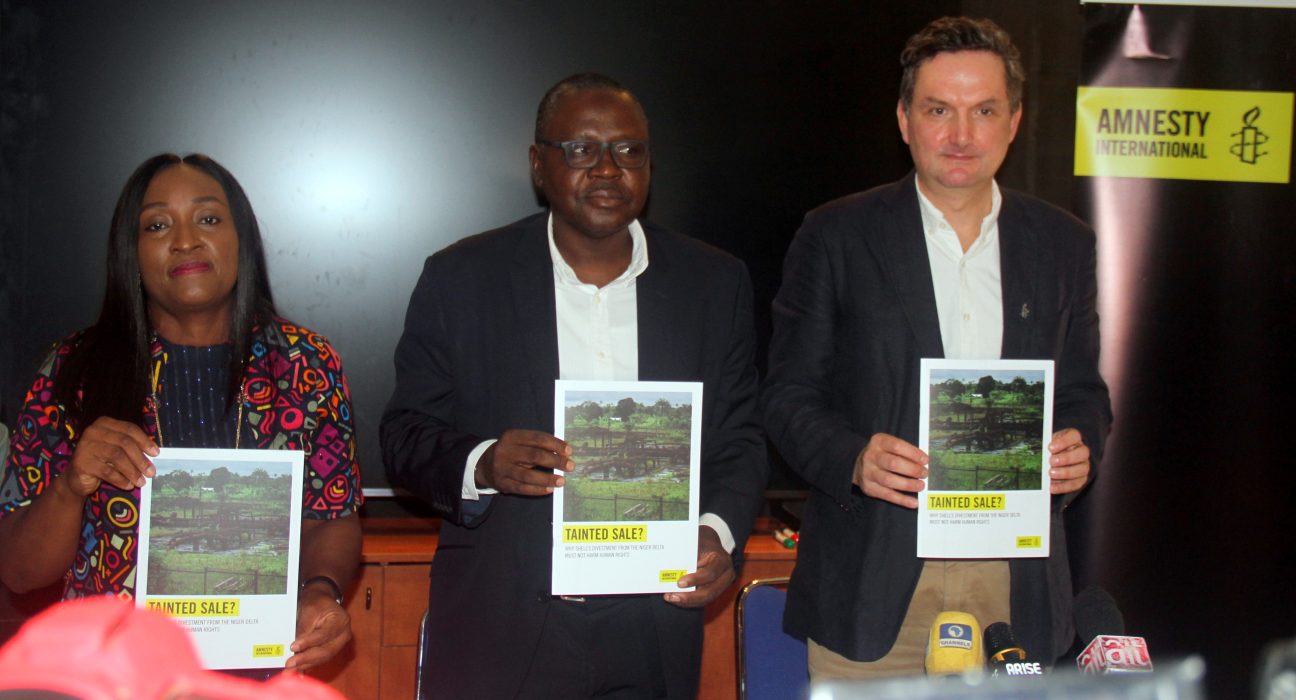 AI Nigeria Country Director, Sanusi Isa (C) flanked by the Head of Business, Security, and Human Rights at AI International Secretariat, Mark Dummett (R) and another AI Nigeria staff (L) during the presentation of the Report on Shell's Divestment in Nigeria