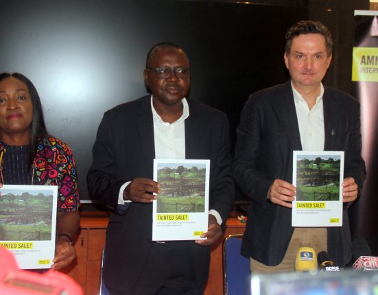 AI Nigeria Country Director, Sanusi Isa (C) flanked by the Head of Business, Security, and Human Rights at AI International Secretariat, Mark Dummett (R) and another AI Nigeria staff (L) during the presentation of the Report on Shell's Divestment in Nigeria