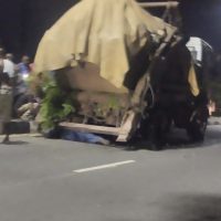 Passers-by and witnesses watch and deliberate the action to take after a waste evacuation truck collapsed on a mechanic along Marian Road in Calabar