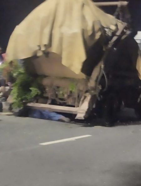 Passers-by and witnesses watch and deliberate the action to take after a waste evacuation truck collapsed on a mechanic along Marian Road in Calabar