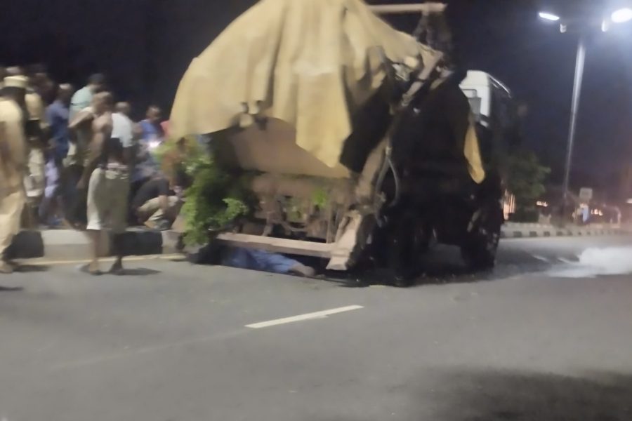 Passers-by and witnesses watch and deliberate the action to take after a waste evacuation truck collapsed on a mechanic along Marian Road in Calabar