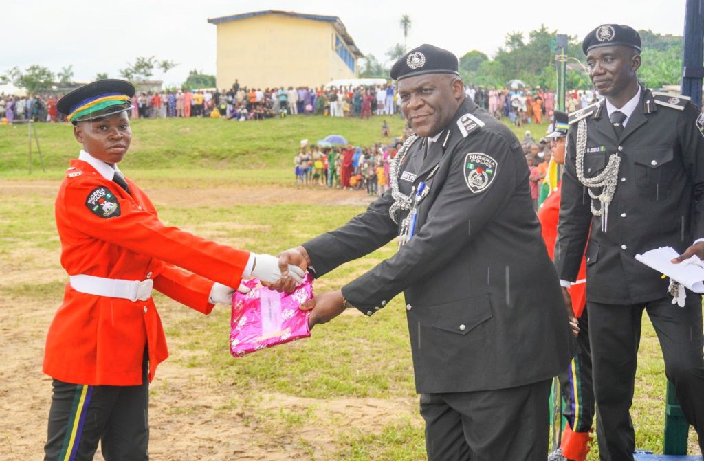 PC Agim Mary shakes CP Rashid Afegbua while ACP Gambo Erena watches on