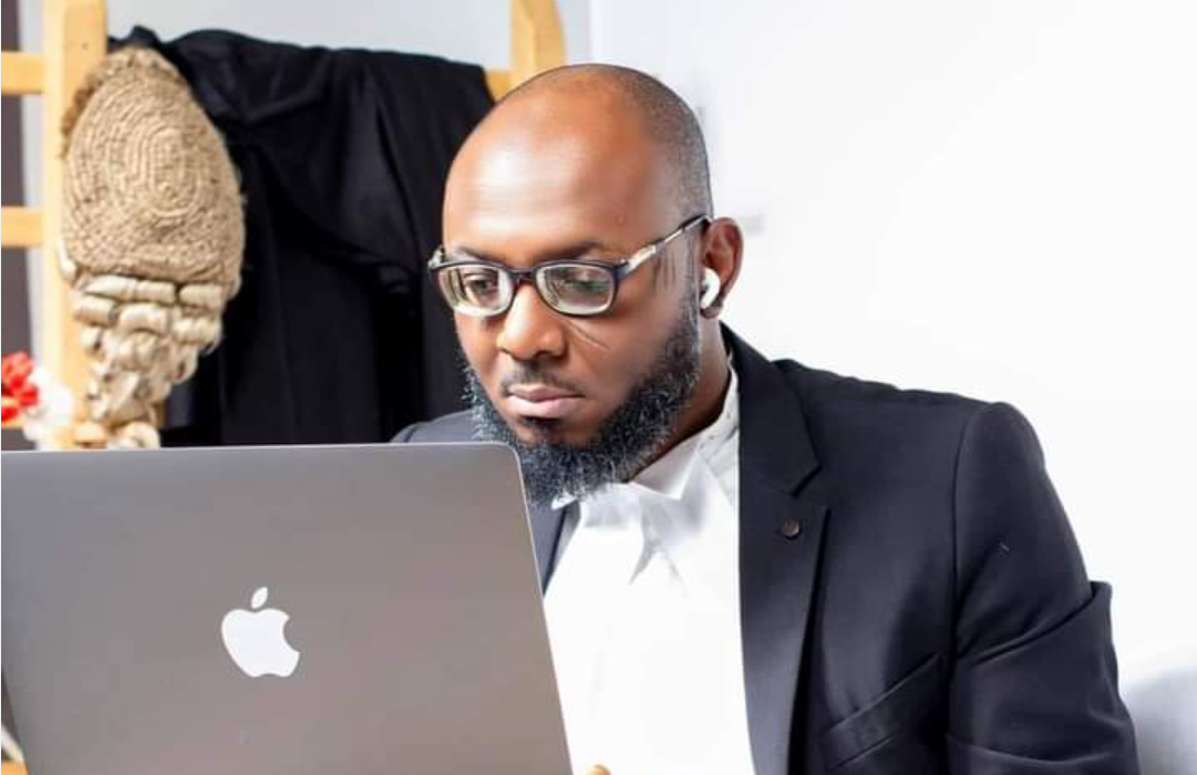 F. Baba Isa examining Section 77 of the Electoral Act on his laptop
